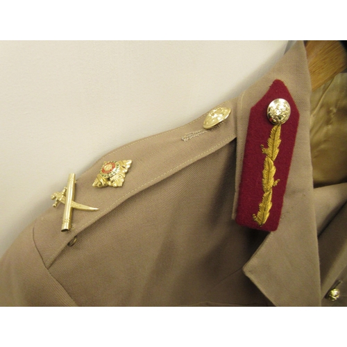 164 - A British Army General's khaki jacket and trousers with buttons, cross swords and baton emblems and ... 