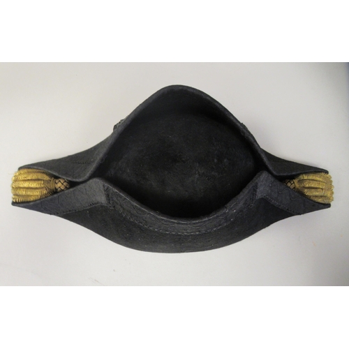 169 - A naval black cocked hat  bears the makers name CJ Chapman of Plymouth in a painted tinplate box  in... 