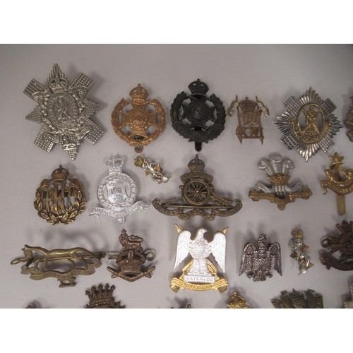 172 - Approx. fifty military cap badges and other insignia, some copies: to include The Honourable Artille... 