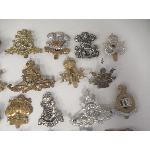 172 - Approx. fifty military cap badges and other insignia, some copies: to include The Honourable Artille... 