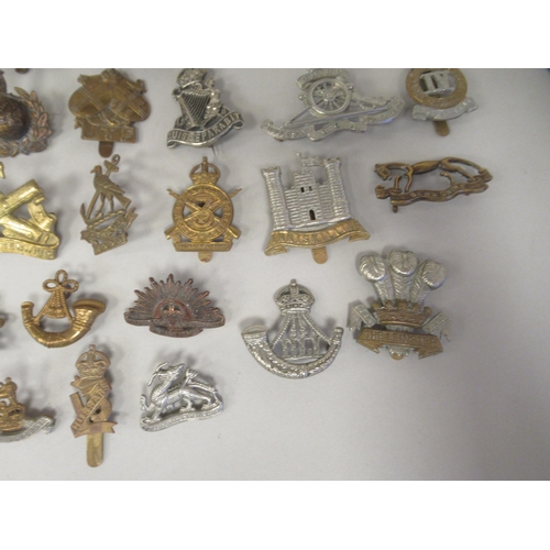 172 - Approx. fifty military cap badges and other insignia, some copies: to include The Honourable Artille... 