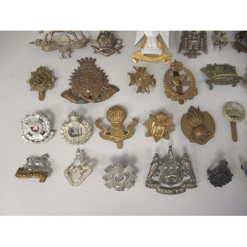 172 - Approx. fifty military cap badges and other insignia, some copies: to include The Honourable Artille... 