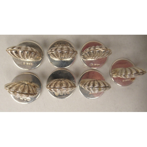 174 - A set of seven silver scallop shell design menu holders, on round stands  T-C  Birmingham ... 