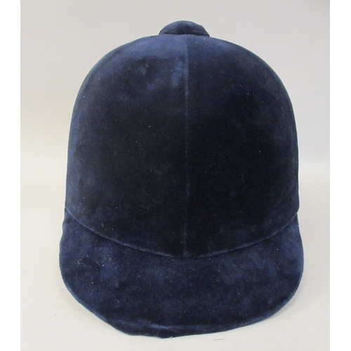 178 - A Christy Beaufort Windsor navy blue velvet covered, flexible peaked riding helmet  size 7.5