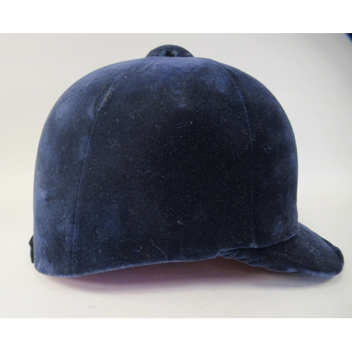 178 - A Christy Beaufort Windsor navy blue velvet covered, flexible peaked riding helmet  size 7.5