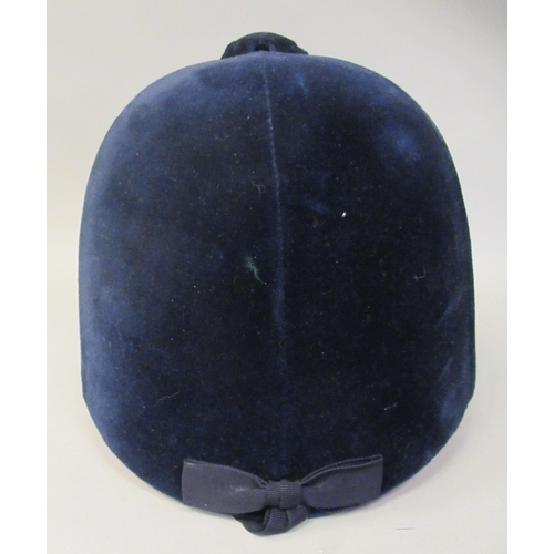 178 - A Christy Beaufort Windsor navy blue velvet covered, flexible peaked riding helmet  size 7.5