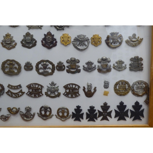 18 - Over one hundred and twenty military cap badges and other insignia, some copies: to include The Dors... 