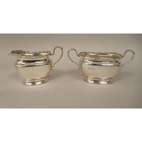 184 - A four piece silver tea set of ogee form with applied wire, wavy rims  comprising a teapot with... 