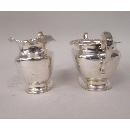 184 - A four piece silver tea set of ogee form with applied wire, wavy rims  comprising a teapot with... 