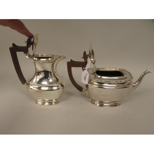 184 - A four piece silver tea set of ogee form with applied wire, wavy rims  comprising a teapot with... 