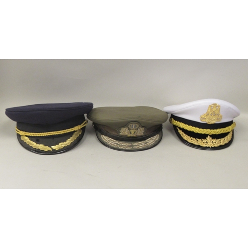 187 - Seven various foreign military officers' peaked uniform hats, decorated with emblems and braid: to i... 