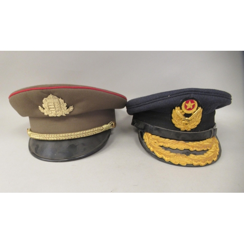 187 - Seven various foreign military officers' peaked uniform hats, decorated with emblems and braid: to i... 