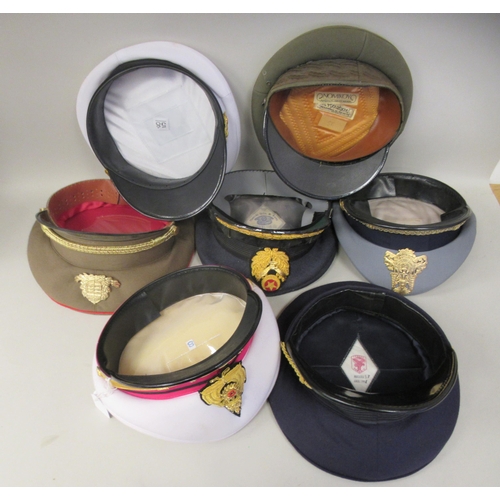 187 - Seven various foreign military officers' peaked uniform hats, decorated with emblems and braid: to i... 