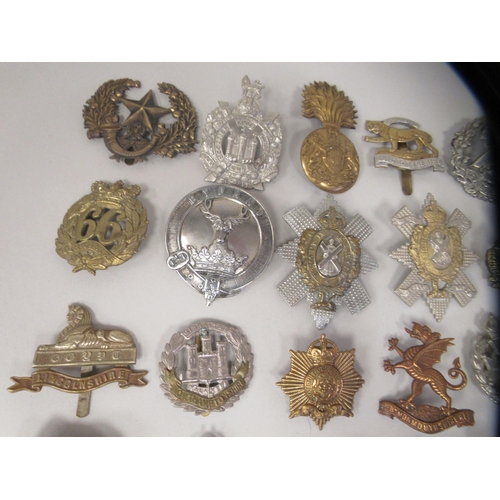 196 - Approx. fifty military cap badges and other insignia, some copies: to include Scottish King Own Bord... 