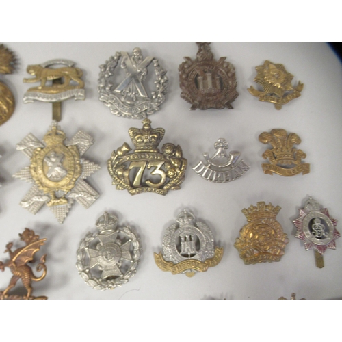 196 - Approx. fifty military cap badges and other insignia, some copies: to include Scottish King Own Bord... 