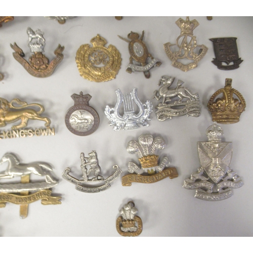 196 - Approx. fifty military cap badges and other insignia, some copies: to include Scottish King Own Bord... 