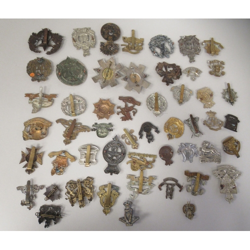 196 - Approx. fifty military cap badges and other insignia, some copies: to include Scottish King Own Bord... 