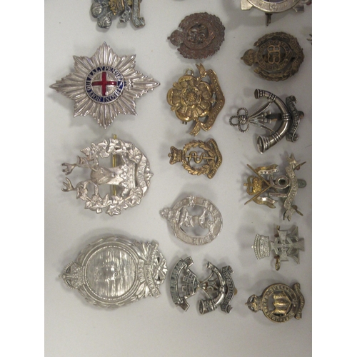 197 - Approx. fifty military cap badges and other insignia, some copies: to include Mine Clearance Service... 