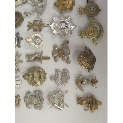 197 - Approx. fifty military cap badges and other insignia, some copies: to include Mine Clearance Service... 