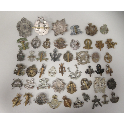 197 - Approx. fifty military cap badges and other insignia, some copies: to include Mine Clearance Service... 