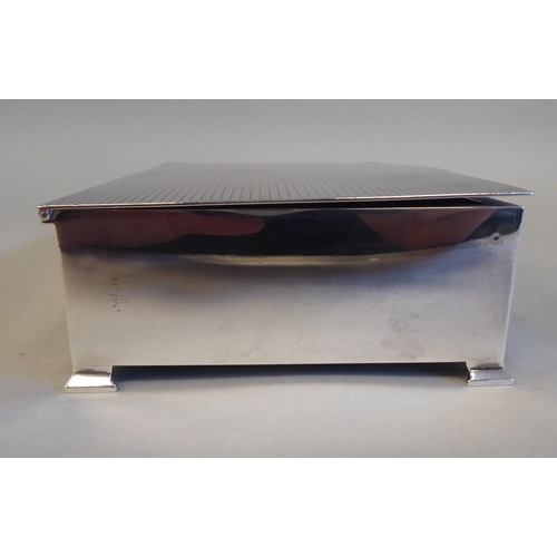 2 - A silver and cedar lined cigarette box with straight sides and engine turned decoration to the hinge... 