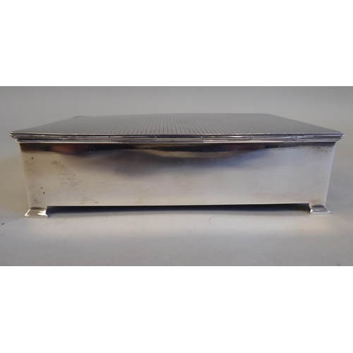 2 - A silver and cedar lined cigarette box with straight sides and engine turned decoration to the hinge... 