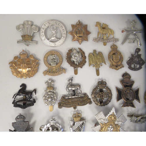 201 - Approx. fifty military cap badges and other insignia, some copies: to include County of London Batt.... 