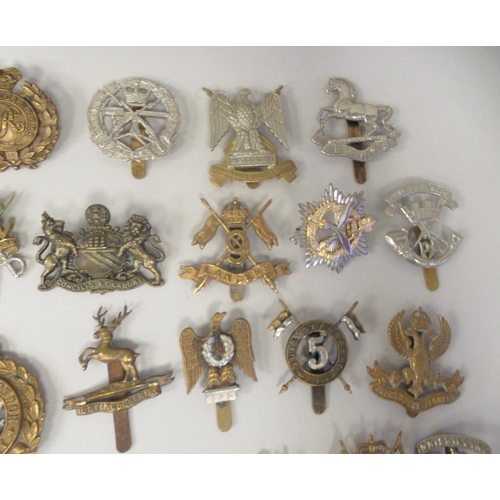 201 - Approx. fifty military cap badges and other insignia, some copies: to include County of London Batt.... 