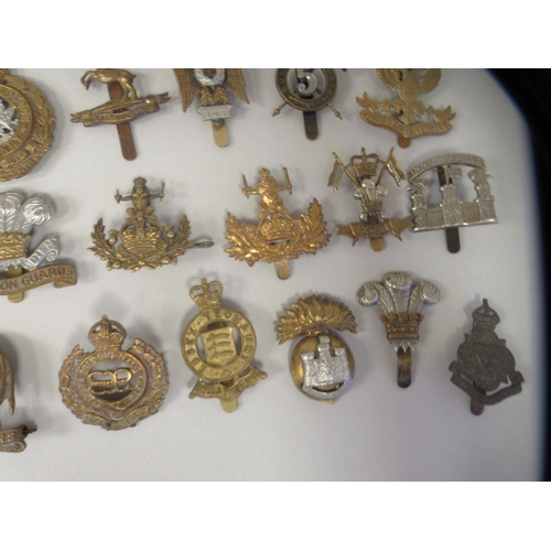 201 - Approx. fifty military cap badges and other insignia, some copies: to include County of London Batt.... 