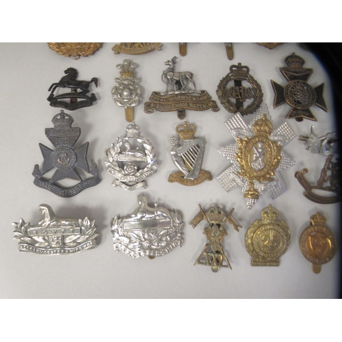 201 - Approx. fifty military cap badges and other insignia, some copies: to include County of London Batt.... 