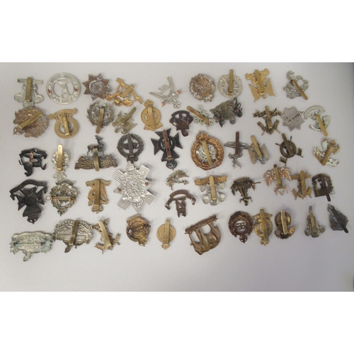 201 - Approx. fifty military cap badges and other insignia, some copies: to include County of London Batt.... 