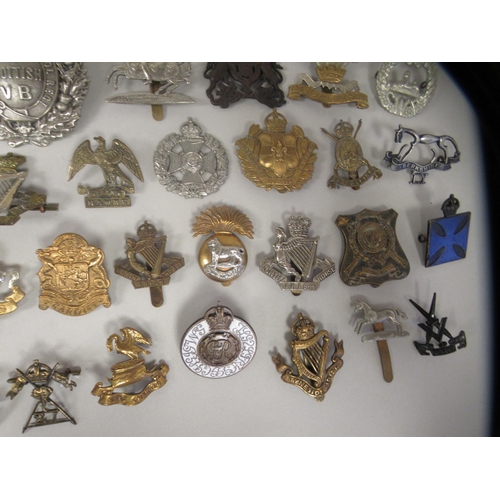 202 - Approx. fifty military cap badges and other insignia, some copies: to include Kings Liverpool Regt.;... 