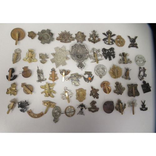 202 - Approx. fifty military cap badges and other insignia, some copies: to include Kings Liverpool Regt.;... 