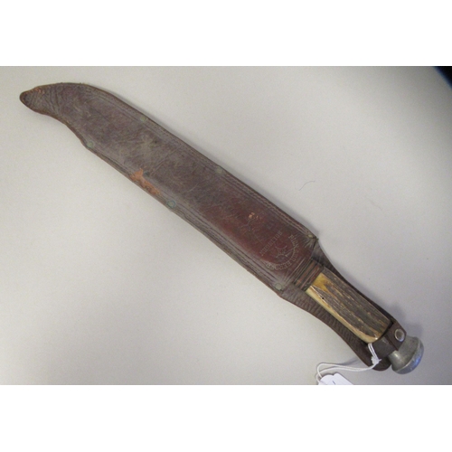 203 - A 1930s German Bowie knife with an aluminium pommel and two part, rough-cut horn handgrip, on a full... 