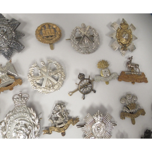 206 - Approx. fifty military cap badges and other insignia, some copies: to include The The Royal Scots Dr... 