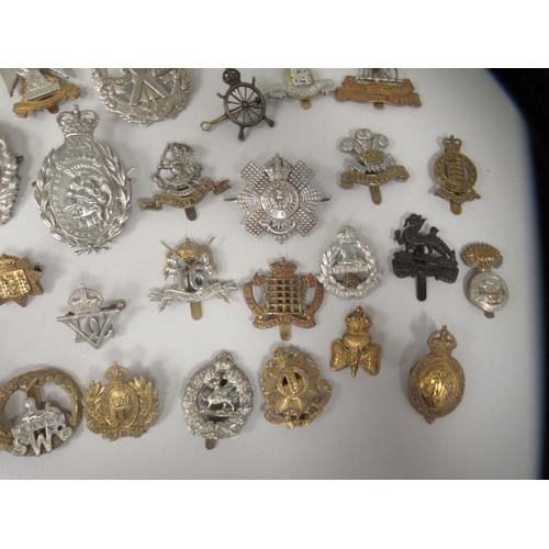 206 - Approx. fifty military cap badges and other insignia, some copies: to include The The Royal Scots Dr... 