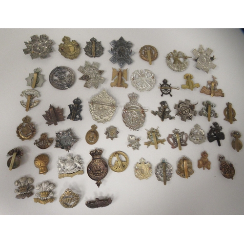 206 - Approx. fifty military cap badges and other insignia, some copies: to include The The Royal Scots Dr... 