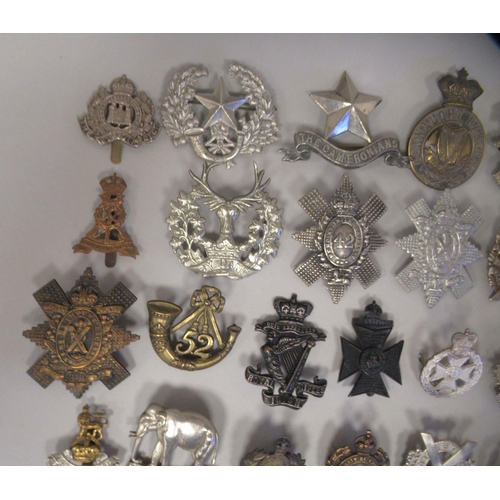 207 - Approx. fifty military cap badges and other insignia, some copies: to include 4th Queen's Own Hussar... 