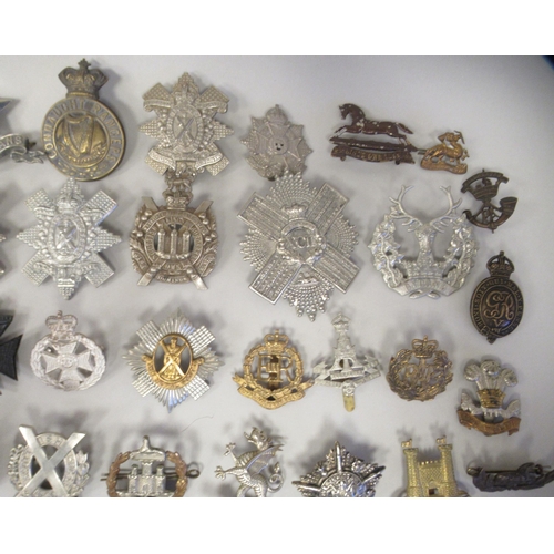 207 - Approx. fifty military cap badges and other insignia, some copies: to include 4th Queen's Own Hussar... 