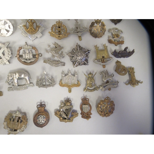 207 - Approx. fifty military cap badges and other insignia, some copies: to include 4th Queen's Own Hussar... 