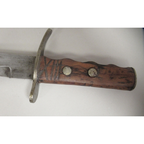 208 - An Italian Fascist era fighting/dress dagger with a rivetted olive wood handgrip, incised with the U... 