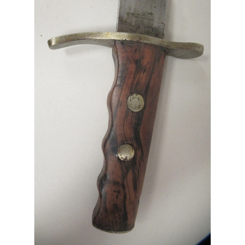 208 - An Italian Fascist era fighting/dress dagger with a rivetted olive wood handgrip, incised with the U... 