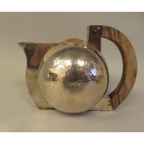 21 - An Art Deco inspired three piece spot-hammered silver tea set of spherical form  comprising a teapot... 