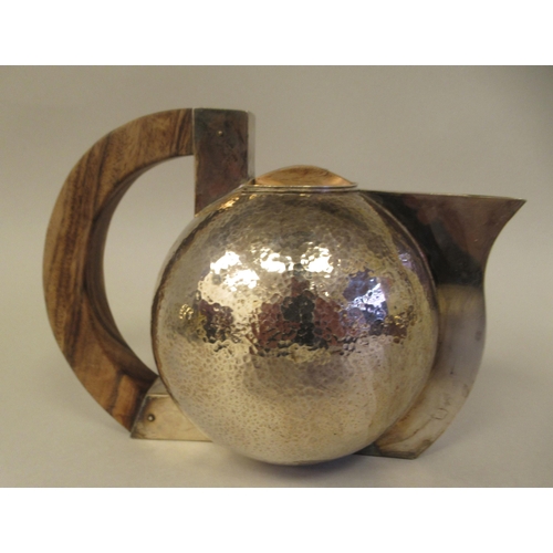 21 - An Art Deco inspired three piece spot-hammered silver tea set of spherical form  comprising a teapot... 