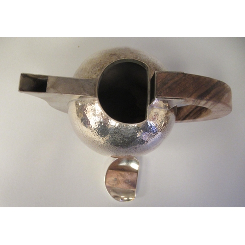 21 - An Art Deco inspired three piece spot-hammered silver tea set of spherical form  comprising a teapot... 