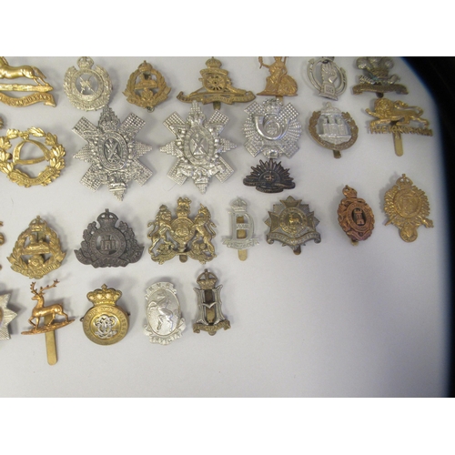 211 - Approx. fifty military cap badges and other insignia, some copies: to include 19th Alexandra PWO Hus... 