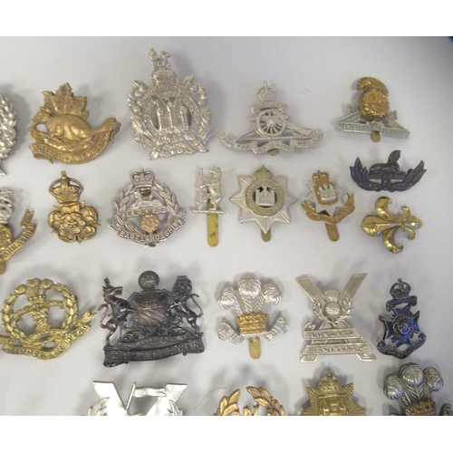 216 - Approx. fifty military cap badges and other insignia, some copies: to include 10 Royal Hussars; The ... 