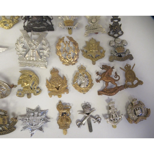 216 - Approx. fifty military cap badges and other insignia, some copies: to include 10 Royal Hussars; The ... 