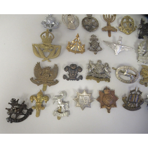 216 - Approx. fifty military cap badges and other insignia, some copies: to include 10 Royal Hussars; The ... 