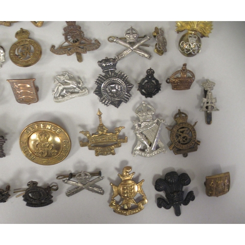 217 - Approx. fifty military cap badges and other insignia, some copies: to include Women's Transport Serv... 